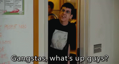 A Man In A Black Shirt Is Standing In A Doorway And Says Gangstas What 'S Up Guys ? GIF