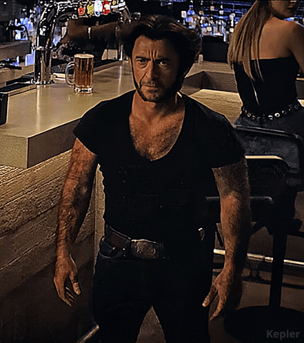 A Man In A Black Shirt Is Standing In Front Of A Bar With The Word Kepler On The Bottom GIF