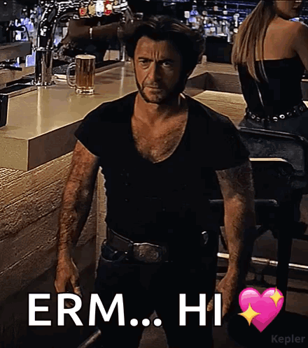 A Man In A Black Shirt Is Standing In Front Of A Bar With The Words " Erm Hi " Above Him GIF