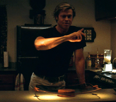A Man In A Black Shirt Is Standing In Front Of A Blender GIF