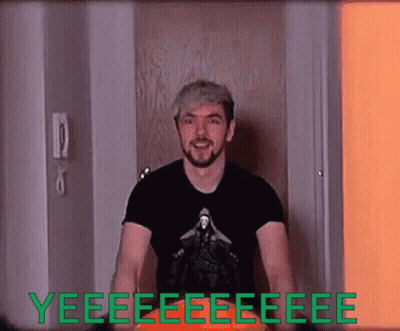 A Man In A Black Shirt Is Standing In Front Of A Door That Says Yeee GIF