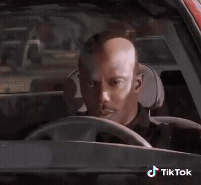 A Man In A Black Shirt Is Standing In Front Of A Police Officer .. GIF