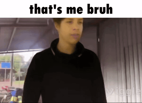 A Man In A Black Shirt Is Standing In Front Of A Sign That Says " That 'S Me Bruh " GIF
