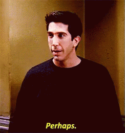 A Man In A Black Shirt Is Standing In Front Of A Wall And Says Perhaps . GIF