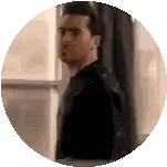A Man In A Black Shirt Is Standing In Front Of A Window Looking Out . Sticker