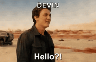 A Man In A Black Shirt Is Standing In The Desert And Says Hello ? GIF