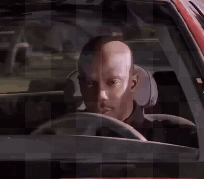 A Man In A Black Shirt Is Standing Next To A Police Officer . GIF