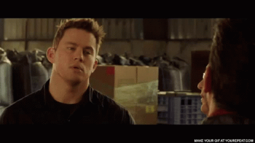 A Man In A Black Shirt Is Talking To A Woman GIF