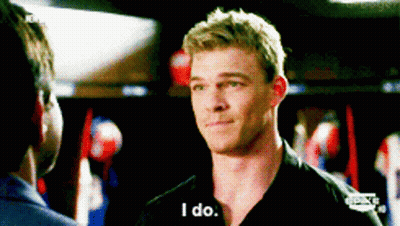 A Man In A Black Shirt Is Talking To Another Man And Says I Do GIF