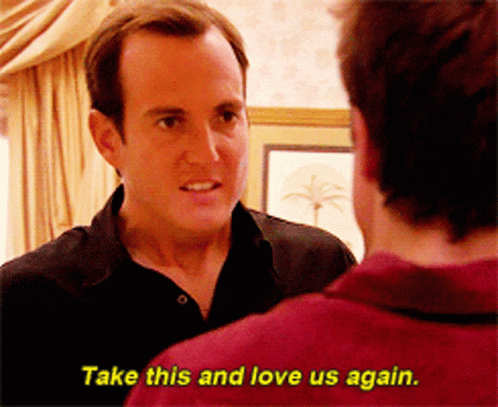 A Man In A Black Shirt Is Talking To Another Man In A Red Shirt Who Says Take This And Love Us Again GIF
