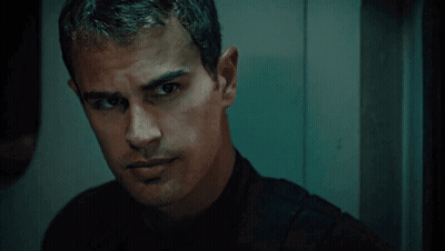 A Man In A Black Shirt Looks At The Camera GIF