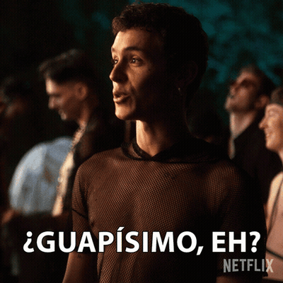 A Man In A Black Shirt Says " Guapisimo Eh " In Front Of A Crowd GIF