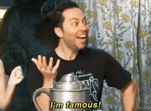 A Man In A Black Shirt Says " I 'M Famous " While Holding A Pitcher GIF