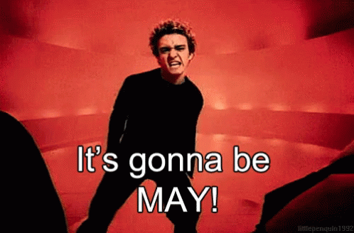A Man In A Black Shirt Says It 'S Gonna Be May In A Red Background GIF