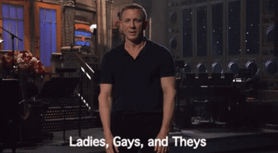 A Man In A Black Shirt Says Ladies Gays And Theys In Front Of A Stage GIF