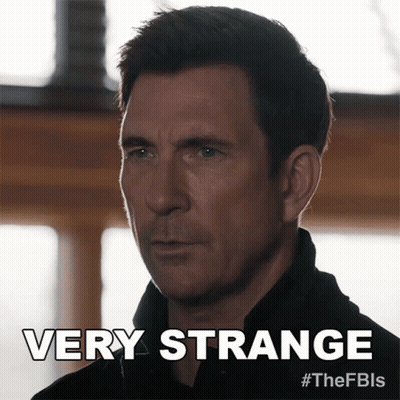 A Man In A Black Shirt Says Very Strange On The Bottom GIF