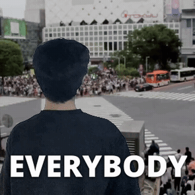 A Man In A Black Shirt Stands In Front Of A Crowd With The Word Everybody On The Bottom Right GIF