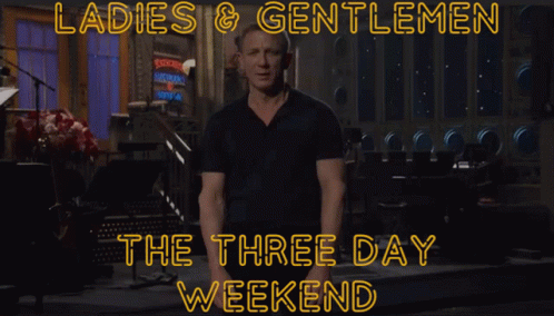 A Man In A Black Shirt Stands In Front Of A Sign That Says Ladies & Gentlemen GIF