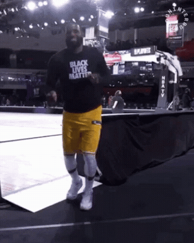 A Man In A Black Shirt That Says Black Lives Matter Is Running On A Basketball Court GIF