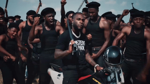 A Man In A Black Shirt That Says Misters Fade Is Holding A Bat GIF