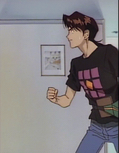 A Man In A Black Shirt With A Purple Square On It GIF