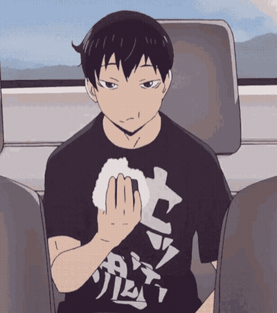 A Man In A Black Shirt With Chinese Writing On It GIF