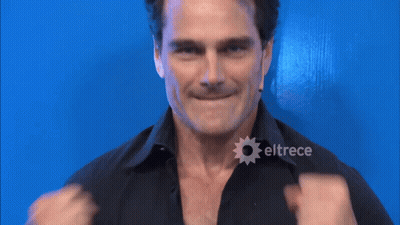 A Man In A Black Shirt With Eltrece On The Bottom Right GIF
