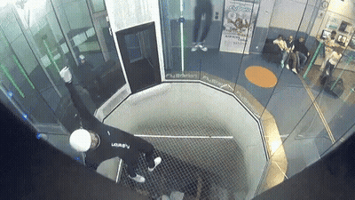 A Man In A Black Shirt With The Letter A On It Is In A Room GIF