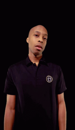 A Man In A Black Shirt With The Letter B On The Front GIF