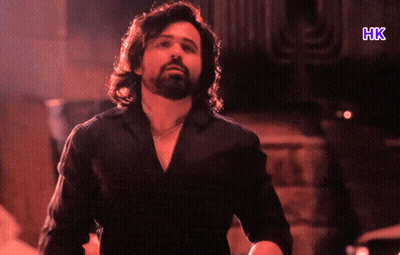 A Man In A Black Shirt With The Letters Hk On The Bottom GIF