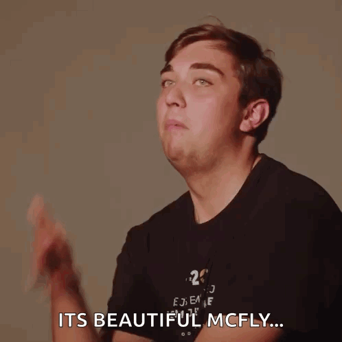 A Man In A Black Shirt With The Number 25 On It Is Making A Funny Face And Says It 'S Beautiful Mcfly GIF