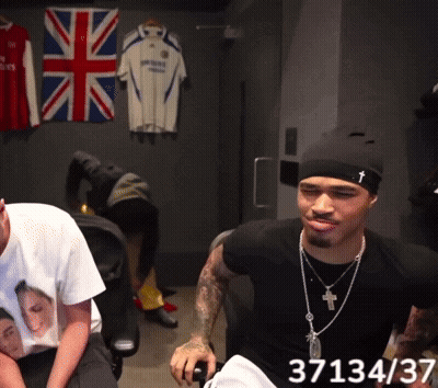 A Man In A Black Shirt With The Number 37134 On The Bottom GIF