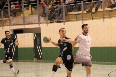 A Man In A Black Shirt With The Word Gaban On It Is Holding A Ball GIF