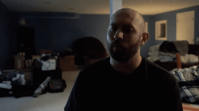 A Man In A Black Shirt With The Word Water Behind Him GIF