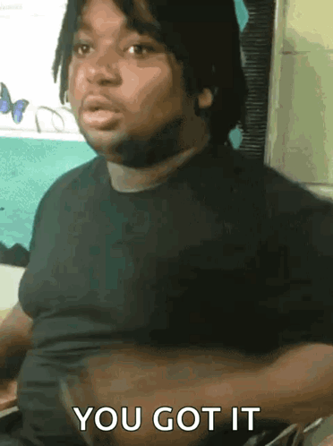 A Man In A Black Shirt With The Words You Got It On The Bottom GIF