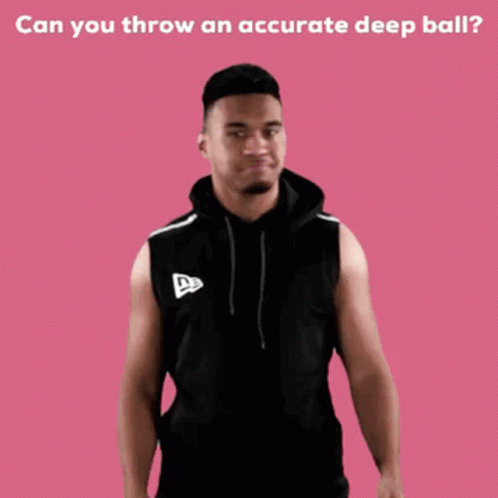 A Man In A Black Sleeveless Hoodie Stands In Front Of A Pink Background With The Words Can You Throw GIF