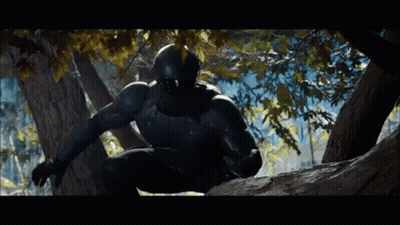 A Man In A Black Suit And Helmet Is Climbing A Tree GIF