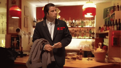 A Man In A Black Suit Has A Red X On His Pocket GIF