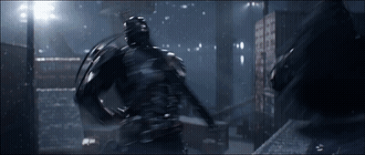 A Man In A Black Suit Is Fighting Another Man GIF