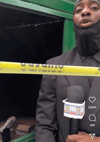 A Man In A Black Suit Is Holding A Microphone With A Lanyard That Says ' Mtn Radio ' On It GIF