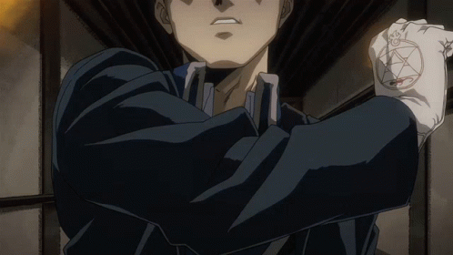 A Man In A Black Suit Is Holding A Pentagram In His Hand GIF