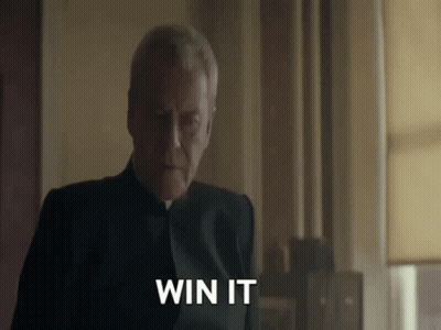 A Man In A Black Suit Is Saying " Win It " GIF