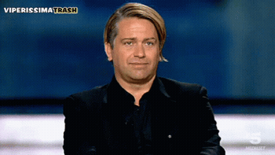 A Man In A Black Suit Is Sitting In Front Of A Screen That Says Viperissimo Trash GIF