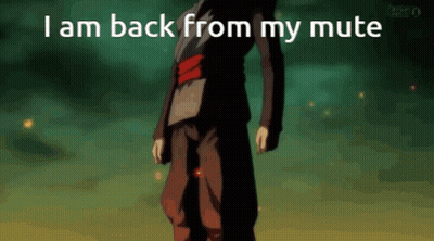 A Man In A Black Suit Is Standing In Front Of A Green Background With The Words I Am Back From My Mute GIF