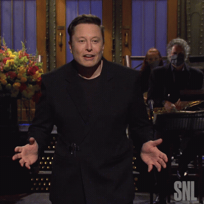 A Man In A Black Suit Is Standing In Front Of A Snl Sign GIF