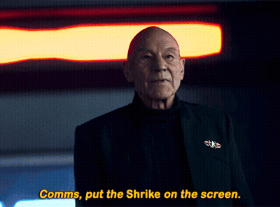A Man In A Black Suit Says Comms Put The Shrike On The Screen GIF