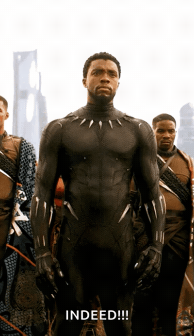 A Man In A Black Suit Stands In Front Of A Group Of Men And The Word Indeed Is Written Below Him GIF