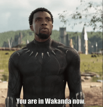 A Man In A Black Suit With The Words You Are In Wakanda Now GIF