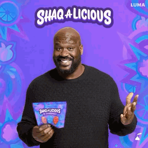 A Man In A Black Sweater Is Holding A Bag Of Gummy Bears And Smiling . GIF