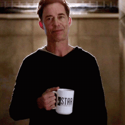 A Man In A Black Sweater Is Holding A Star Mug GIF